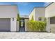 Modern home entrance with stone accents, a paved walkway, and green vine-covered walls at 787 Willits St, Las Vegas, NV 89138