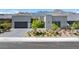 Contemporary home with a neutral color palette and manicured landscaping against a mountain backdrop at 787 Willits St, Las Vegas, NV 89138