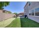 Lush backyard with a putting green and patio area, ideal for relaxation and recreation at 7890 S Miller Ln, Las Vegas, NV 89113