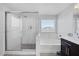 Bright bathroom featuring a glass-enclosed shower, separate tub, and modern fixtures at 7890 S Miller Ln, Las Vegas, NV 89113