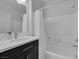 Modern bathroom featuring a sleek vanity, bathtub, and shower with stylish finishes at 7890 S Miller Ln, Las Vegas, NV 89113