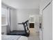 Bedroom with treadmill, ensuite bathroom, and closet; a perfect space for workouts and relaxation at 7890 S Miller Ln, Las Vegas, NV 89113