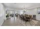 Open-concept dining area with modern chandelier, and seamless flow to living room at 7890 S Miller Ln, Las Vegas, NV 89113