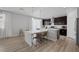 Modern kitchen with dark cabinets, a long island, and a bright eating nook at 7890 S Miller Ln, Las Vegas, NV 89113