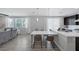 Open kitchen boasts modern design, white countertops, dark cabinets, and stainless steel appliances at 7890 S Miller Ln, Las Vegas, NV 89113