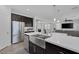 Stainless steel farmhouse sink and appliances pair well with dark cabinets and white countertops at 7890 S Miller Ln, Las Vegas, NV 89113