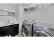 Well-equipped laundry room featuring modern washer and dryer, plus ample storage and stylish decor at 7890 S Miller Ln, Las Vegas, NV 89113
