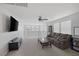 Spacious living area, featuring a comfortable sofa, a large TV, and expansive windows at 7890 S Miller Ln, Las Vegas, NV 89113