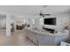 Spacious living room with open floor plan, hardwood floors, and comfortable sectional sofa at 7890 S Miller Ln, Las Vegas, NV 89113