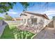Outdoor view of the home’s backyard highlighting the greenery, brick patio, and exterior architecture at 7920 Turtle Island Ct, Las Vegas, NV 89129