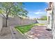 Private backyard featuring well-maintained landscaping, defined grass areas, and a brick patio at 7920 Turtle Island Ct, Las Vegas, NV 89129