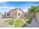 An outdoor space with artificial grass patches, a brick patio, rock landscaping, and block wall fencing at 7920 Turtle Island Ct, Las Vegas, NV 89129