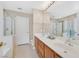 Primary bathroom features a dual sink vanity, large mirror, and a glass shower at 7920 Turtle Island Ct, Las Vegas, NV 89129