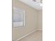 Minimalist bedroom features a ceiling fan, carpeting, and one window, allowing ample natural light at 7920 Turtle Island Ct, Las Vegas, NV 89129
