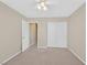 Neutral carpeted bedroom featuring a large closet with sliding doors and an open doorway at 7920 Turtle Island Ct, Las Vegas, NV 89129
