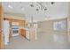 Open-concept kitchen includes a white oven, wooden cabinets, tile flooring, and access to a large living area at 7920 Turtle Island Ct, Las Vegas, NV 89129
