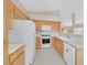 Well-lit kitchen features white appliances, light wood cabinets and easy access to adjacent living space at 7920 Turtle Island Ct, Las Vegas, NV 89129