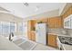 Bright kitchen with white appliances, plenty of cabinets, and a breakfast bar overlooking the living area at 7920 Turtle Island Ct, Las Vegas, NV 89129