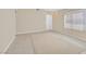 Spacious living room featuring tile flooring, neutral paint, and large window with light-filtering blinds at 7920 Turtle Island Ct, Las Vegas, NV 89129