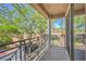 Covered balcony with decorative railings providing a view of green trees, road, and blue sky at 801 Dana Hills Ct # 101, Las Vegas, NV 89134