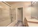 Well-lit bathroom featuring a shower-tub combination, white tile, and a light wood vanity at 801 Dana Hills Ct # 101, Las Vegas, NV 89134