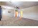 Open bedroom layout with plush carpet, a ceiling fan, natural light, and access to bathrooms at 801 Dana Hills Ct # 101, Las Vegas, NV 89134