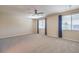Spacious bedroom with plush carpet, natural light, and a ceiling fan with views of the greenery at 801 Dana Hills Ct # 101, Las Vegas, NV 89134