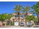 Exterior view of townhomes with palm trees, well-maintained landscaping, and two-car garages at 801 Dana Hills Ct # 101, Las Vegas, NV 89134