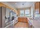 Well-lit kitchen with stainless steel appliances, tile countertops, wood cabinets, and natural light at 801 Dana Hills Ct # 101, Las Vegas, NV 89134