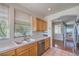 Bright kitchen featuring tile countertops, stainless steel appliances, and wood cabinets with easy access at 801 Dana Hills Ct # 101, Las Vegas, NV 89134