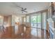 Open living room with hardwood floors, ceiling fan, and sliding glass doors to balcony at 801 Dana Hills Ct # 101, Las Vegas, NV 89134