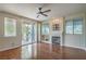 Bright living room with fireplace, hardwood floors, ceiling fan, and access to balcony at 801 Dana Hills Ct # 101, Las Vegas, NV 89134