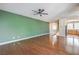 Spacious living room featuring hardwood floors, a modern ceiling fan, and an open layout to the kitchen at 801 Dana Hills Ct # 101, Las Vegas, NV 89134