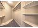 Organized walk-in closet featuring shelving, wooden rods, and ample storage space at 801 Dana Hills Ct # 101, Las Vegas, NV 89134