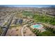 Aerial view of a planned community with parks, pool, and mountain views at 817 Cottonwood Hill Pl, Henderson, NV 89011