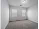 A bright bedroom with neutral walls, plush carpeting, and two windows at 817 Cottonwood Hill Pl, Henderson, NV 89011