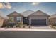 Charming single-story home featuring a two-car garage, desert landscaping, and a welcoming front porch at 817 Cottonwood Hill Pl, Henderson, NV 89011