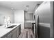 Modern kitchen featuring stainless steel appliances, gray cabinets, an island, and wood-look flooring at 817 Cottonwood Hill Pl, Henderson, NV 89011