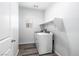 Bright laundry room featuring a washer, dryer, and storage shelving at 817 Cottonwood Hill Pl, Henderson, NV 89011