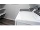 Well-lit laundry room featuring modern, front-loading, white Whirlpool washer and dryer, and convenient shelving at 817 Cottonwood Hill Pl, Henderson, NV 89011
