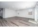 Spacious living room with light gray wood-look flooring, recessed lighting, and ample natural light at 817 Cottonwood Hill Pl, Henderson, NV 89011