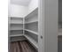 Well-organized walk-in pantry with ample shelving and wood-look flooring at 817 Cottonwood Hill Pl, Henderson, NV 89011
