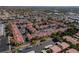 Overview of a community boasting red tile roofs, central pool, and tree-lined streets at 8455 W Sahara Ave # 289, Las Vegas, NV 89117