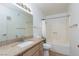 Bathroom features a granite countertop, tan cabinets, and a shower-tub combo at 8455 W Sahara Ave # 289, Las Vegas, NV 89117