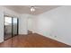 Bedroom with laminate floors, fan, and sliding glass door to balcony at 8455 W Sahara Ave # 289, Las Vegas, NV 89117