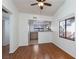 Bright dining room features hardwood floors, modern ceiling fan, and flows into the kitchen with updated appliances at 8455 W Sahara Ave # 289, Las Vegas, NV 89117