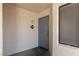 Entryway featuring a gray door, exterior light, unit number, and welcome mat at 8455 W Sahara Ave # 289, Las Vegas, NV 89117