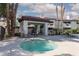 Community hot tub surrounded by palm trees and lounge chairs at 8455 W Sahara Ave # 289, Las Vegas, NV 89117