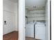 Laundry room with white washer and dryer units, shelving for storage at 8455 W Sahara Ave # 289, Las Vegas, NV 89117