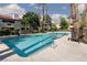 Sparkling community pool surrounded by palm trees and lounge chairs at 8455 W Sahara Ave # 289, Las Vegas, NV 89117